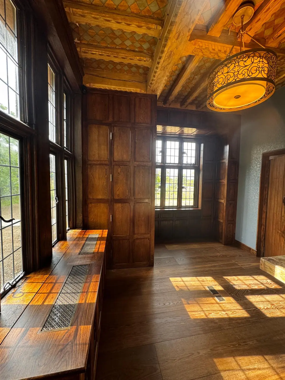 The same room with the new panelling finished to match the older wood